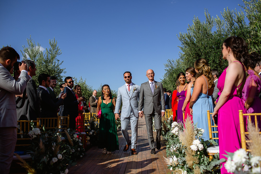 noivo entra com os pais para o casamento entre as vinhas na adega vistalba em mendoza